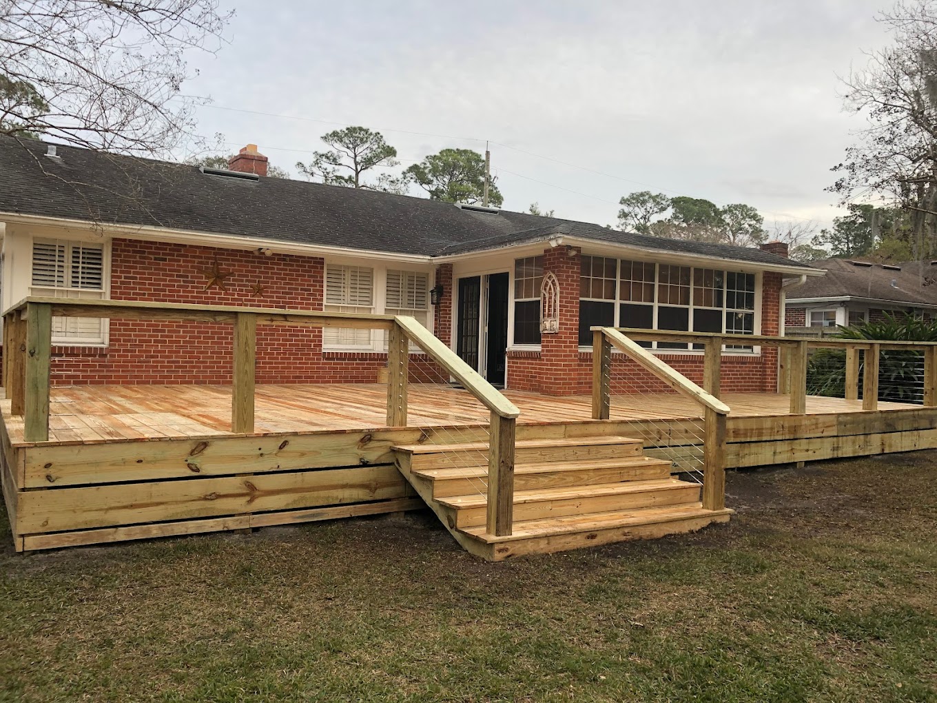 Wood deck with steps and railing at Jacksonville home
