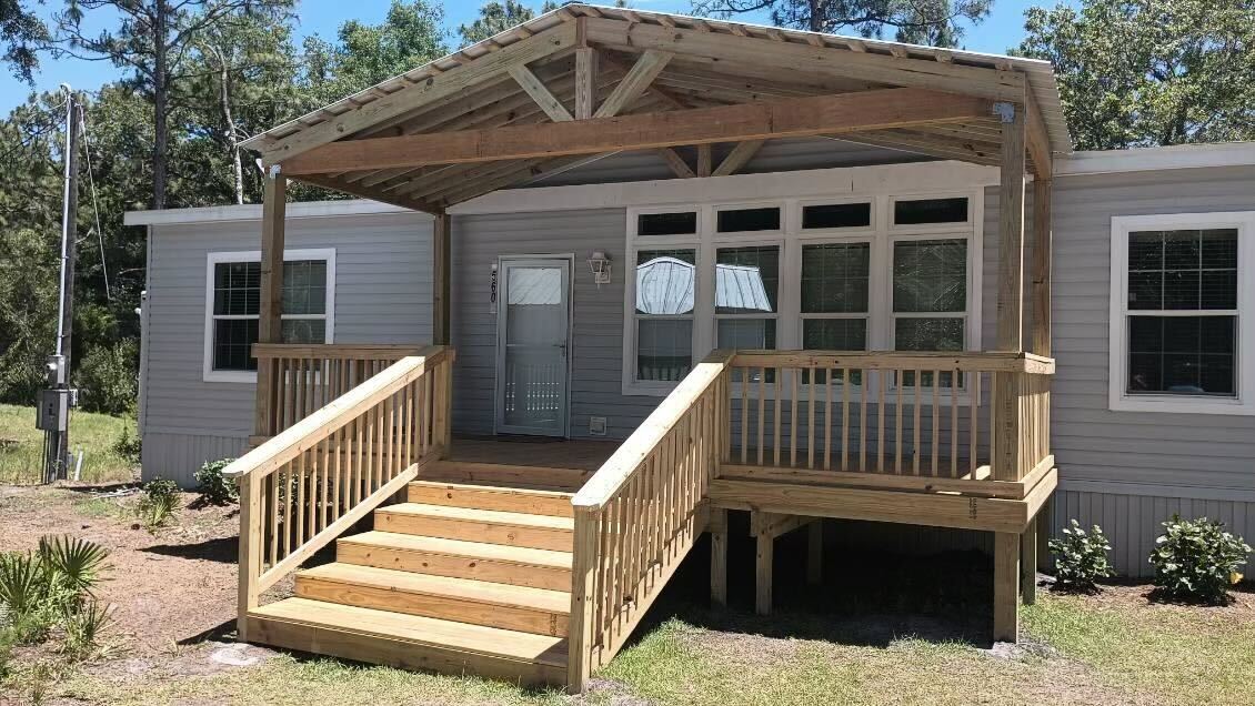 Wood deck with stairs and covered entry at a Jacksonville home