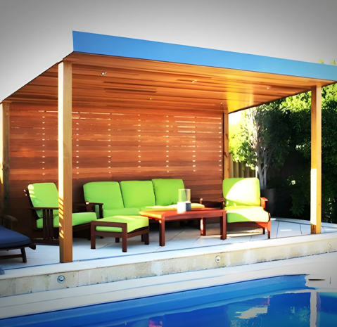 Poolside pergola with wooden paneling and green outdoor seating