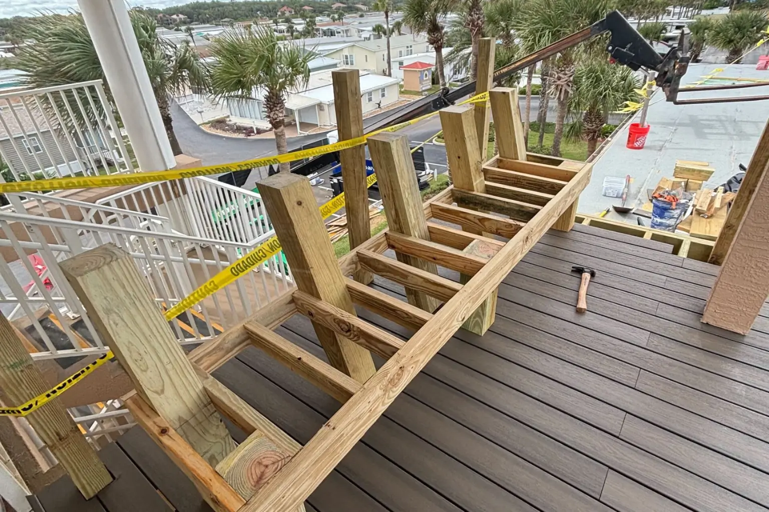 Rooftop deck construction with wooden framework and tools.